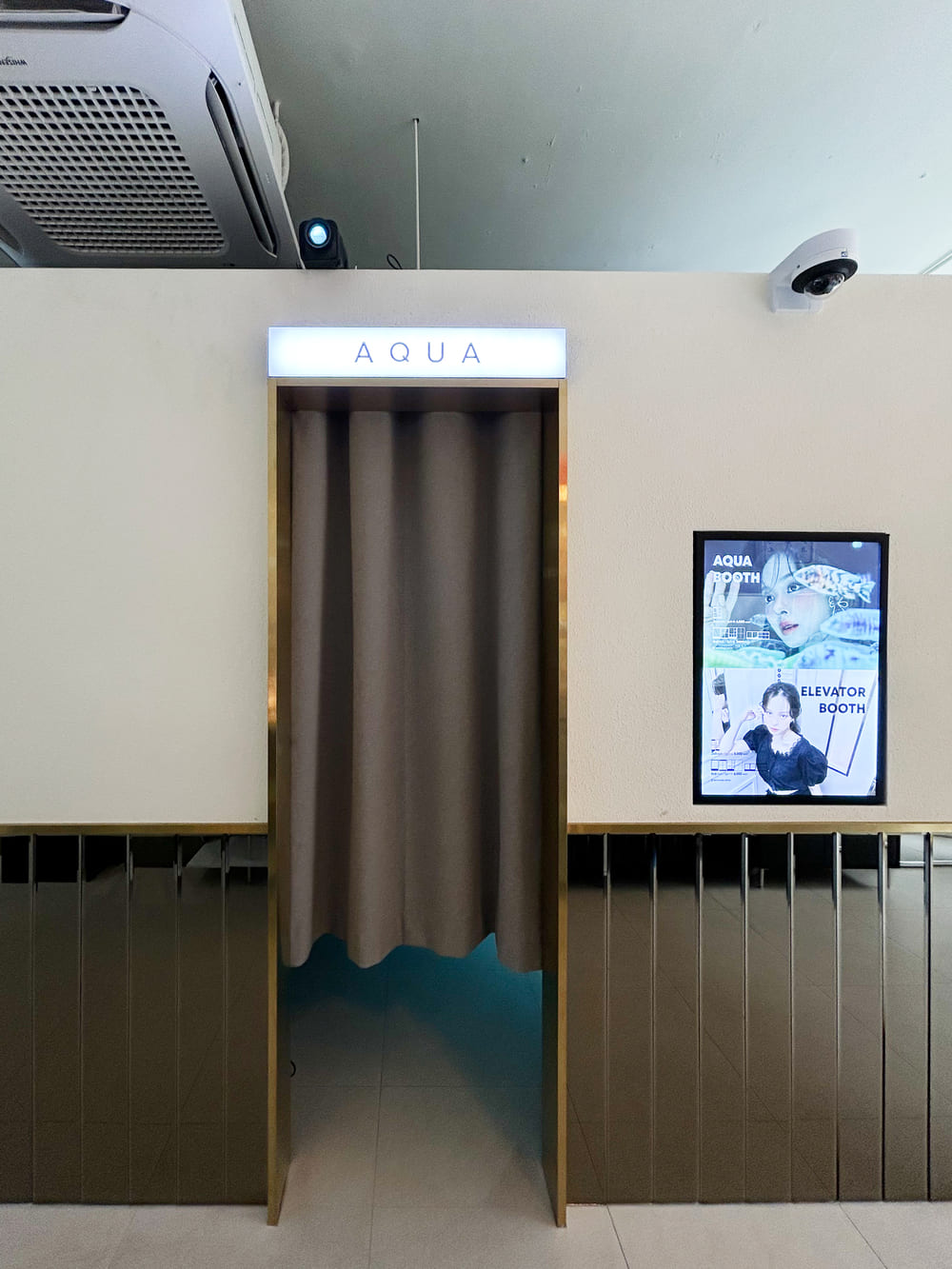Aqua Booth interior with aquarium tanks and soft lighting
